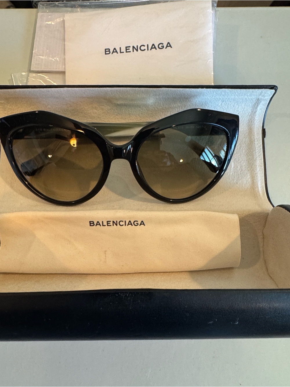 Balenciaga Black Cat-Eye Sunglasses with Brown Gradient Lenses.